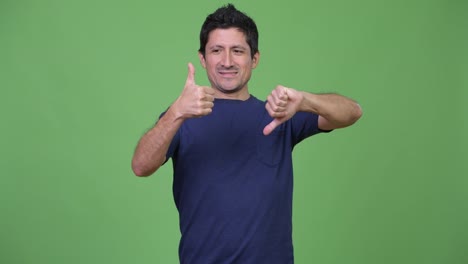 Hispanic-man-choosing-between-thumbs-up-and-thumbs-down