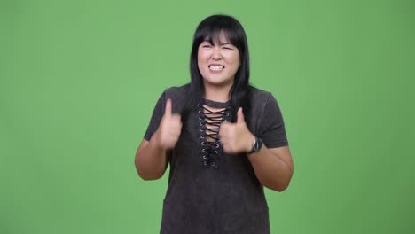 Happy-overweight-Asian-woman-giving-thumbs-up