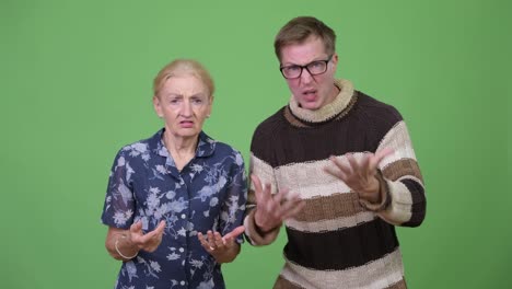 Angry-grandmother-and-grandson-talking-and-gesturing-in-rage-together