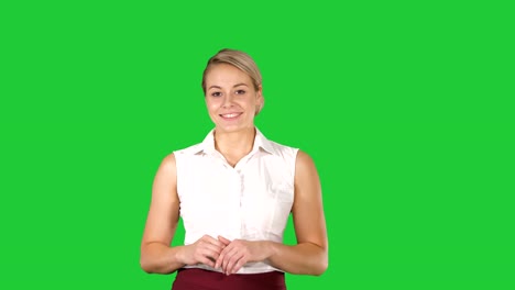 Beautiful-woman-walking-and-smiling-to-the-camera-on-a-Green-Screen,-Chroma-Key