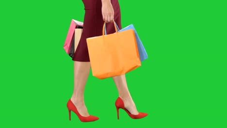 Legs-of-shopping-lady-with-shopping-bags-on-a-Green-Screen,-Chroma-Key