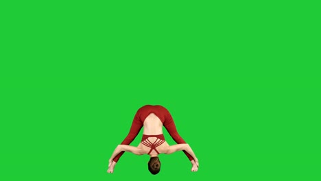 Young-woman-in-forward-bending-asana-yoga-pose-on-a-Green-Screen,-Chroma-Key