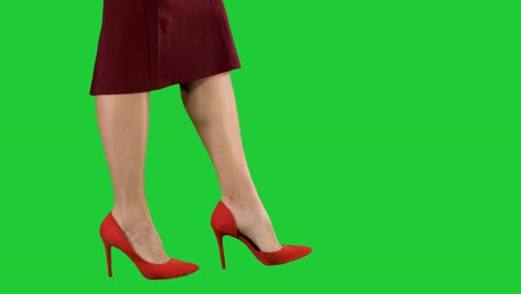 Sexy-woman-legs-in-red-heels-walking-Business-lady-on-a-Green-Screen,-Chroma-Key