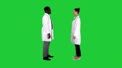 Successful-team-of-surgeons-giving-high-five-and-laughing-isolated-on-white-background-on-a-Green-Screen,-Chroma-Key