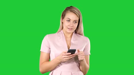 Blonde-girl-holding-mobile-phone-Young-woman,-cellphone-addiction,-online-dating-app,-communication,-new-technologies,-trendy-concepts-on-a-Green-Screen,-Chroma-Key