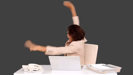 Businesswoman-celebrating-at-her-desk