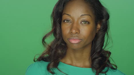 Beautiful-African-American-woman-looking-tough-and-staring,-on-a-green-screen-studio-background