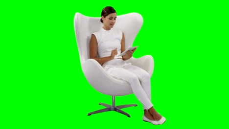 A-woman-sitting-and-using-digital-tablet