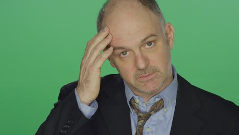 Middle-aged-businessman-looking-exhausted,-on-a-green-screen-studio-background