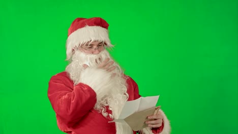 Santa-Claus-reading-letters-from-children-on-a-Green-Screen-Chrome-Key