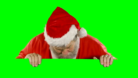 Überrascht-Weihnachtsmann-versteckt-sich-hinter-green-screen