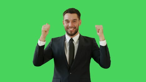 Medium-Shot-of-a-Handsome-Businessman-Making-Win-Gestures-and-Rejoycing.-Celebrating-His-Success.-Background-is-Green-Screen.