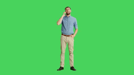 Long-Shot-if-a-Handsome-Man-Talking-on-a-Headset.-Shot-on-Green-Screen-Background.
