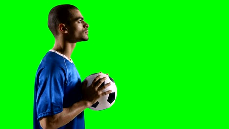 Profile-of-football-player-holding-a-football