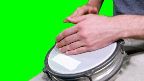 Mid-section-of-drummer-playing-drum