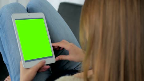 Woman-using-tablet-computer-with-green-screen