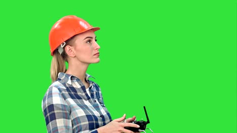 Female-engineer-operating-a-drone-analyzing-object-on-a-Green-Screen,-Chroma-Key