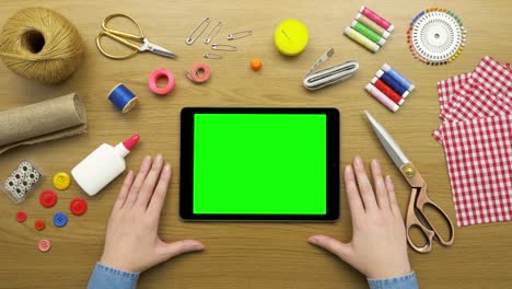 Overhead-Shot-Of-Woman-With-Digital-Tablet-And-Sewing-Accessories