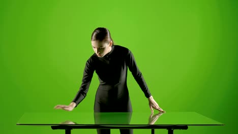 Attractive-girl-young-fashion-model-virtual-touch-screen-gesture-shot-in-green-screen-studio-.-Interactive-futuristic-gesture-.-Medium-shot-.-Prores-shoot-on-Blackmagic-Ursa-Mini-Pro