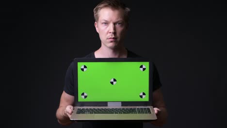 Man-Holding-Laptop-With-Chroma-Key-Green-Screen
