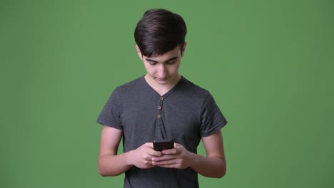 Young-handsome-Iranian-teenage-boy-against-green-background