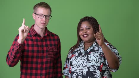 Overweight-African-woman-and-young-Scandinavian-man-together-against-green-background