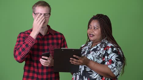 Overweight-African-woman-and-young-Scandinavian-man-together-against-green-background