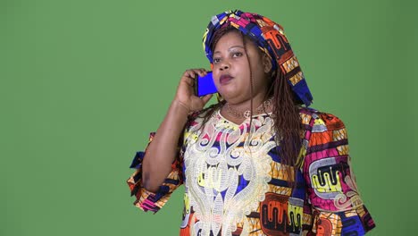 Overweight-beautiful-African-woman-wearing-traditional-clothing-against-green-background