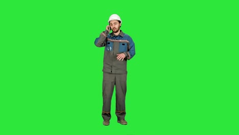 Construction-Worker-talk-with-Cell-Telephone-on-a-Green-Screen,-Chroma-Key