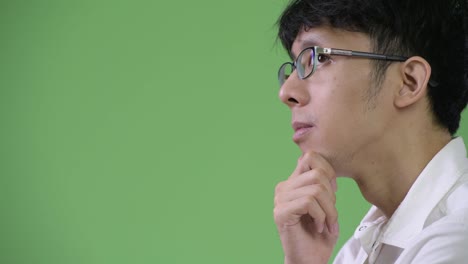 Profile-view-of-young-Asian-businessman-thinking