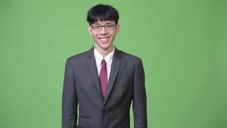 Young-happy-Asian-businessman-smiling