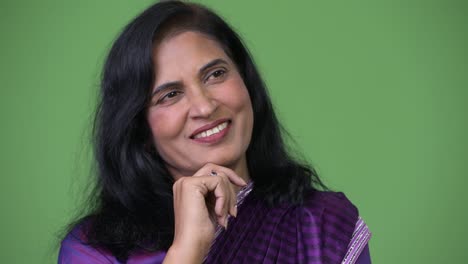 Close-up-shot-of-mature-happy-beautiful-Indian-woman-thinking-while-wearing-Sari-traditional-clothes