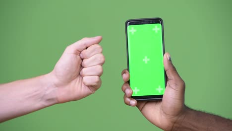 Two-multi-ethnic-hands-showing-phone-while-giving-thumbs-down