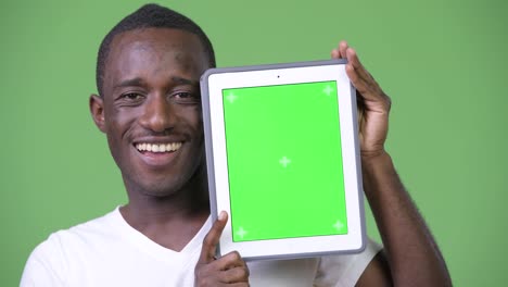 Young-happy-African-man-showing-digital-tablet