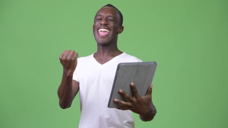 Young-happy-African-man-using-digital-tablet