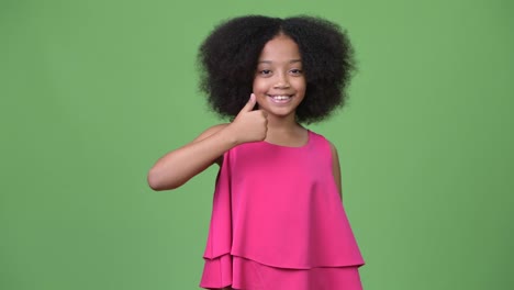 Young-cute-African-girl-with-Afro-hair-giving-thumbs-up