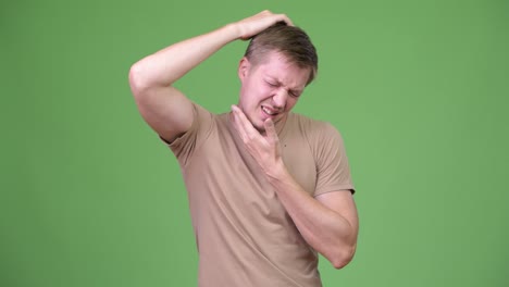 Young-tired-Scandinavian-man-having-neck-pain