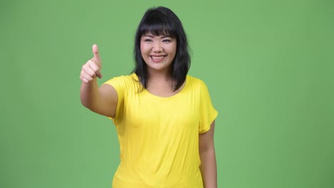 Beautiful-happy-Asian-woman-giving-thumbs-up