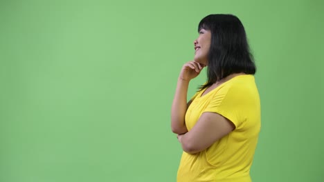 Profile-view-of-beautiful-happy-Asian-woman-thinking