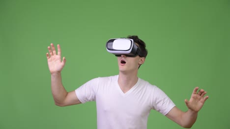 Young-handsome-man-using-virtual-reality-headset