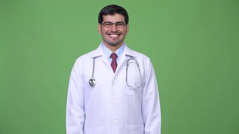 Young-handsome-Persian-man-doctor-smiling