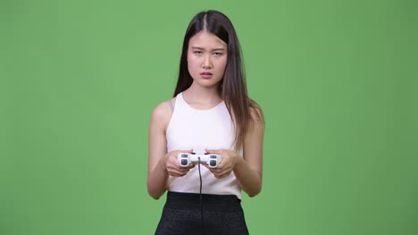 Young-beautiful-Asian-businesswoman-playing-games