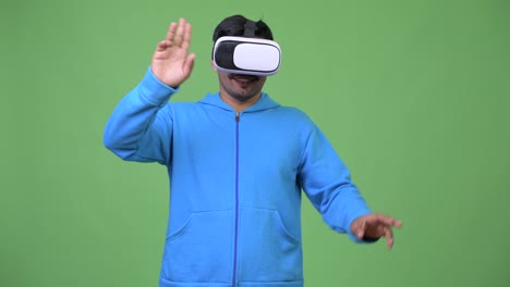 Young-handsome-Persian-man-using-virtual-reality-headset