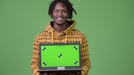 Young-handsome-African-man-showing-laptop
