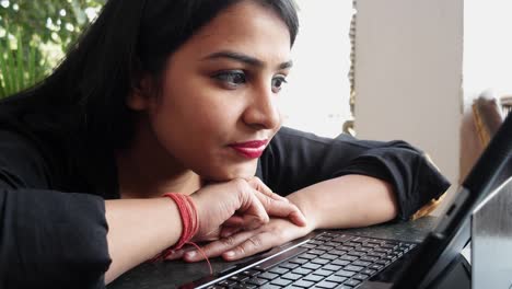 Indian-lady-working-on-a-tablet-with-a-keyboard-computer-at-home-in-Rajasthan,-India