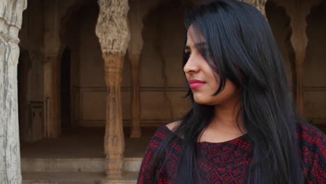 Cute-young-lady-angry-looks-around-smiles-happy-livid-points-finger-straight-at-camera-warns-giving-instructions-order-firing-pissed-lover-POV-handheld-mid-shot-date-late-consequences-at-a-temple