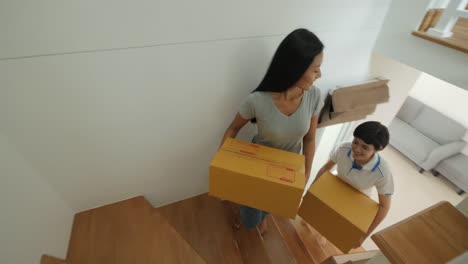 Happy-asian-women-LGBT-lesbian-couple-holding-boxes-entering-new-modern-house