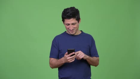 Happy-Hispanic-man-using-phone