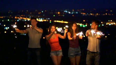 The-four-people-stand-with-bengal-lights.-evening-night-time,-slow-motion