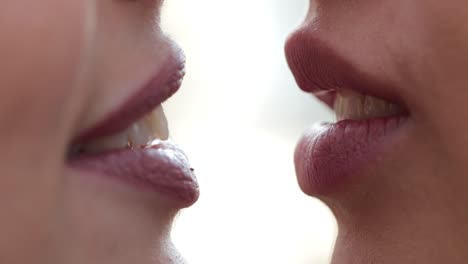 Close-up-of-women-lips-smiling-and-talking-to-each